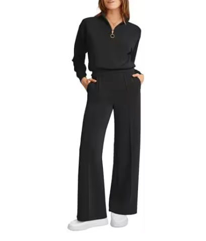 Mulher usando conjunto Royal Comfort coral: blusa meio-zip e calça wide leg de moletom premium, visual elegante e confortável com mãos nos bolsos.